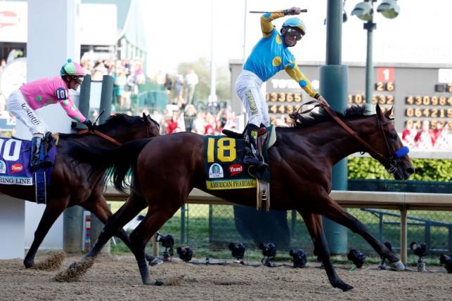 May 2, 2015; Louisville, KY, USA; Victor Espinoza aboard American Pharoah celebrates winning the 141st Kentucky Derby at Churchill Downs. Mandatory Credit: Peter Casey-USA TODAY